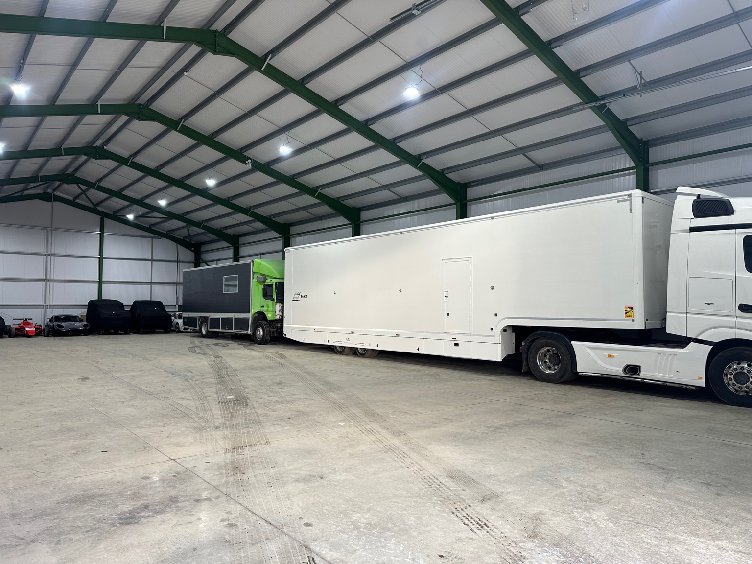 Race lorry and support vehicles inside the facility